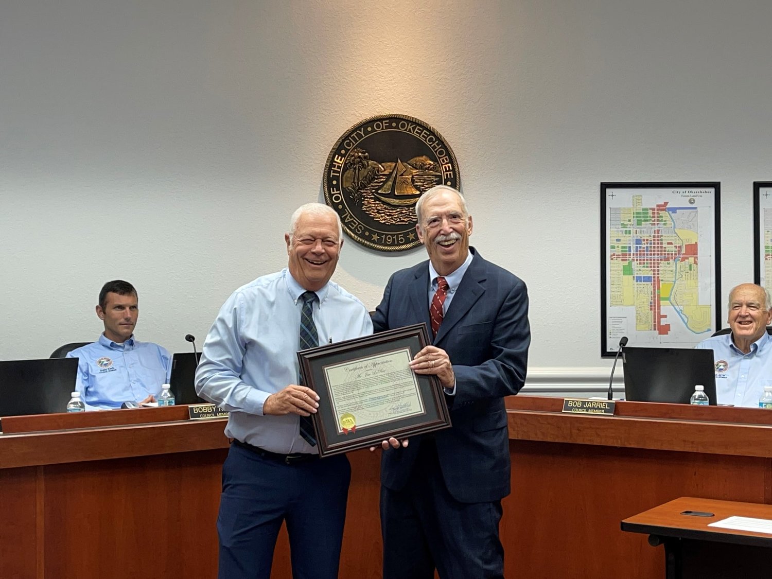 Jim LaRue (right) is presented with a certificate of appreciation for his many years of service to the city.